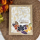 Handmade fall greeting card featuring a gold foiled botanical frame, colorful autumn leaves, and an Autumn Greetings sentiment.