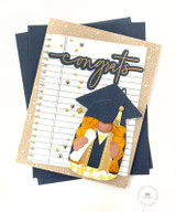 Handmade greeting card with gnome on it in cap and gown with congrats sentiment on it.