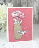 Handmade greeting card with flower in vase and celebrate you sentiment on it.