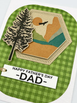 Handmade greeting card of mountains and a tree with happy father's day dad sentiment on it.