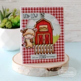 Handmade greeting card with a farm on it and a cow with holy cow sentiment and it's an udder birthday sentiment on it.