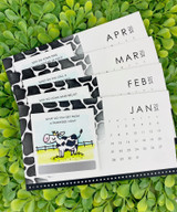 Four handmade calendars with cows on each.
