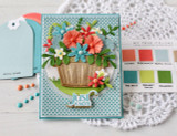 Handmade greeting card with flowers in a pail and just a note sentiment on it with crafting materials in background.