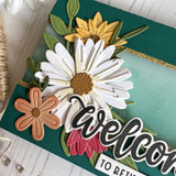 Up close of handmade greeting card with flowers on it and welcome sentinment.
