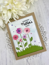 Handmade greeting card with flowers on it and happy mother's day sentiment on it.