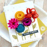 Handmade greeting card with flowers on it and thanks a bunch sentiment on it and cardstock in background.