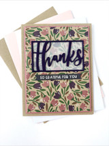 Handmade greeting card with flowers on it and thanks, so grateful for you sentiments on it with cardstock in background.