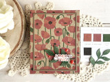 Handmade greeting card with flowers on it and sending hugs sentiment on it with crafting materials in background. Handmade greeting card with flowers on it and sending hugs sentiment on it with crafting materials in background.