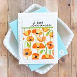 Handmade greeting card with flowers on it and just because sentiment on it with cardstock in background.