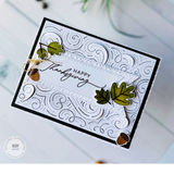 Handmade greeting card with leaves and acorns on it with happy thanksgiving sentiment on it.