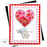 Handmade greeting card with heart on it and happy valentine's day sentiment on it with cardstock in background.