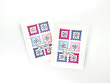 Two handmade greeting cards with snowflakes and postage on it with sending hugs sentiment on it.