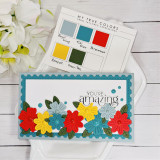 Handmade greeting card with flowers on it and you're amazing sentiment on it with flowers in background.