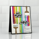 Handmade greeting card with two paint brushes, paint, and a paint can with you brighten my day sentiment and yo are work of art sentiment on it.