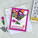 Handmade greeting card with flowers on it and happy belated birthday sentiment on it.