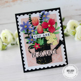 Handmade greeting card with flowers on it and you are beautiful sentiments on it with flowers in background.