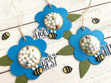 Handmade gift tags with shaker flowers and bumble bees on them with sentiments on it.