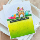 Handmade greeting card with a little bunny on it with flowers on it and social vegan: avoid meet sentiment on it with cardstock in background.