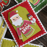 Handmade greeting card with Santa Claus on it with let is snow sentiment on it with snowman on it.