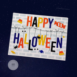 Handmade greeting card with halloween candy on it and happy halloween sentiment on it.