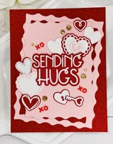 Handmade greeting card with hearts and keys on it with sending hugs sentiment on it.