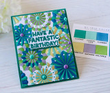 Handmade greeting card with paper fans on it and have a fantastic brithday sentiment on it with crafting materials in background.