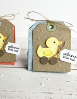 Handmade greeting tag with a toy duck on it and welcome little one sentiment on it.