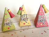 Three pyramids shaped as party hats with let's celebrate on them.