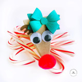 A handmade pyramid giftable shaped as a reindeer with bow on it.