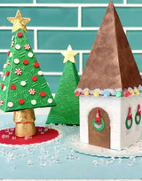 Two handmade Christmas tree pyramids and one house pyramid box used for gifting.