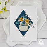 Handmade greeting card with flowers in a basket and hello sentiment on it.