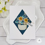 Handmade greeting card with flowers in a basket and hello sentiment on it.