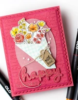 Handmade greeting card with various flowers in a bouquet on it with happy sentiment on it.
