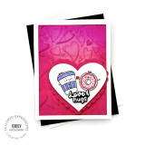 Handmade greeting card with hearts on it and a big heart in the center with love and hugs sentiment with a coffee cup and donut holding a heart in the center with cardstock in background.