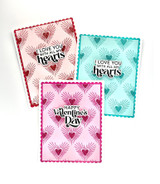 Three handmade greeting cards with hearts on it and the first two cards with I love you with all my hearts sentiments on it and the third one with a happy valentine's day sentiment on it.