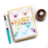 Handmade greeting card with colorful hearts on it and hugs, love you sentiments on it.