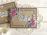 Handmade greeting card with flowers on it and thinking of you sentiment in the center with cards in the background.