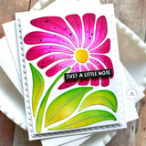 Handmade greeting card of a flower with just a little note sentiment on it with cardstock in background.