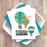 Handmade greeting card with three hot air ballons on it and floating by just to say hi sentiment on it.