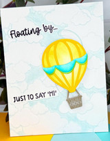 Handmade greeting card with hot air balloon on it and floating by just to say hi sentiment on it.