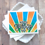 Handmade greeting card with colorful rays on it and happy father's day sentiment on it.