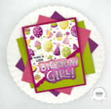 Handmade birthday card with make a wish and birthday girl sentiment with colorful cards in background.
