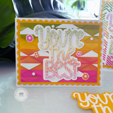A handmade greeting card with you're the best sentiment and plant in background.