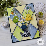 Handmade greeting card with hello there sentiment and flowers in vases with craft supplies in background.