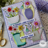 Handmade greeting card with if friends were flowers I'd pick you sentiment with flowers, rainboot, and water can with crafting supplies in background.