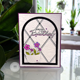 Handmade greeting card with happy birthday sentiment with flowers in a pot.