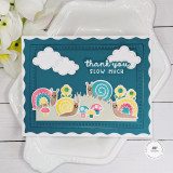 Handmade greeting card with mushrooms, flowers, and snails with thank you slow much sentiment on it with flowers in background.