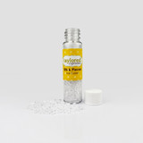 Clear container filled with small cube-shaped embellishments resembling ice cubes, designed for use in paper crafting projects.