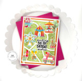 Handmade greeting card that is carnival themed with sending big top birthday wishes sentiment on it with cardstock in background.
