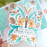 Handmade greeting card with a butterfly on it with you matter let hope uplift you sentiments on it with card in background.